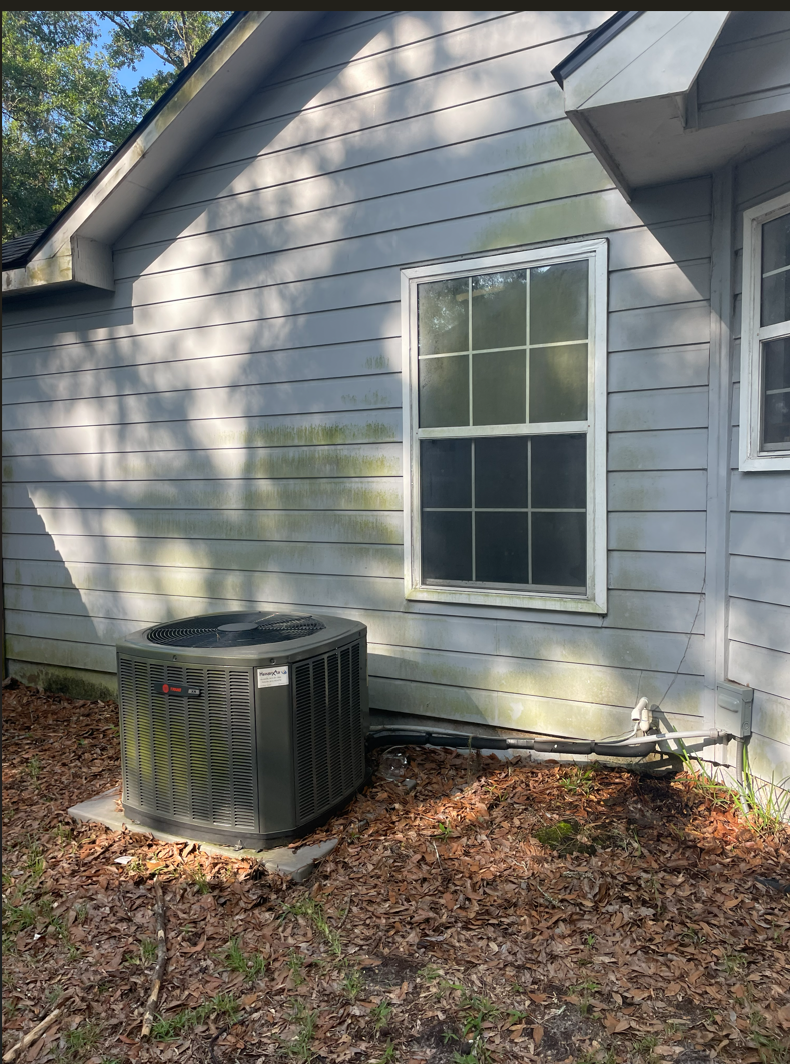 House siding before soft washing with algae and green staining